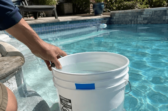A bucket on a pool step for the bucket test