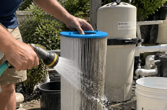 A dirty filter cartridge being rinsed