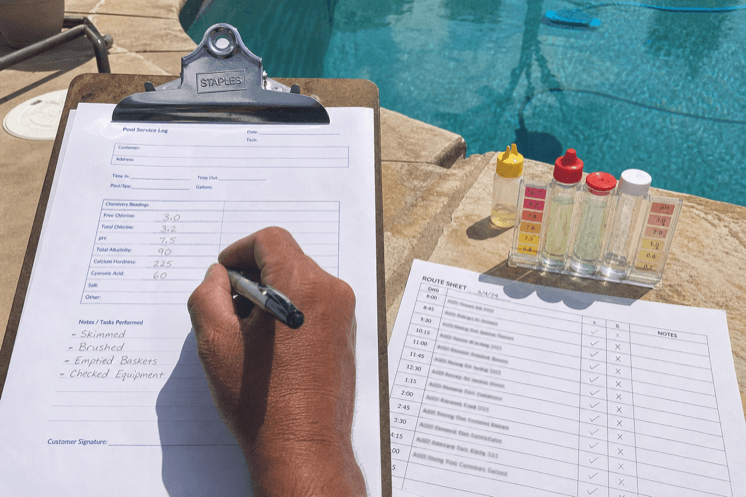 A technician writing service readings on a slip