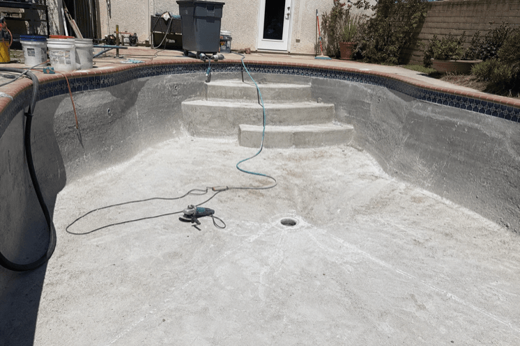 A drained pool shell mid-renovation