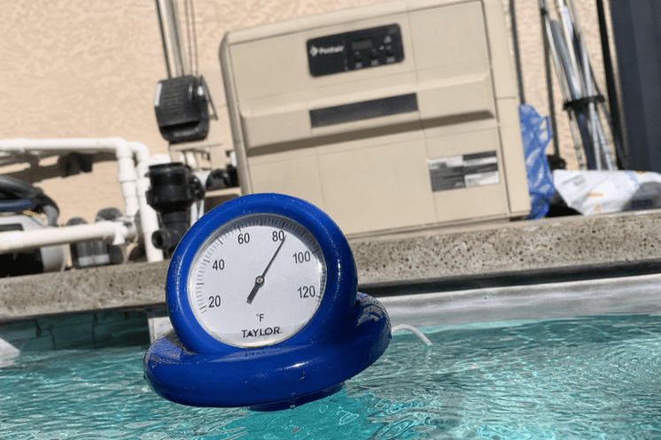A floating pool thermometer at the waterline