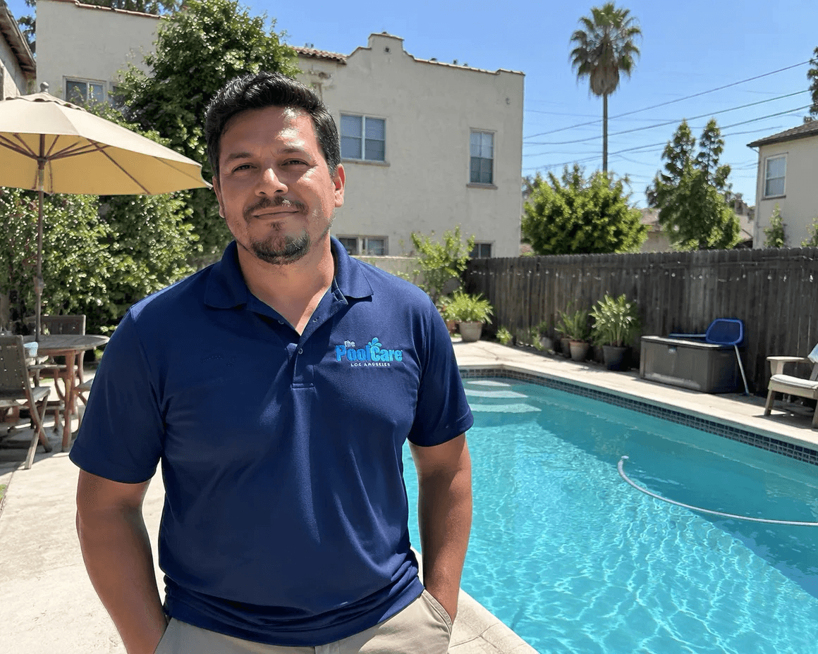 The owner of Pool Care LA beside a Hollywood backyard pool