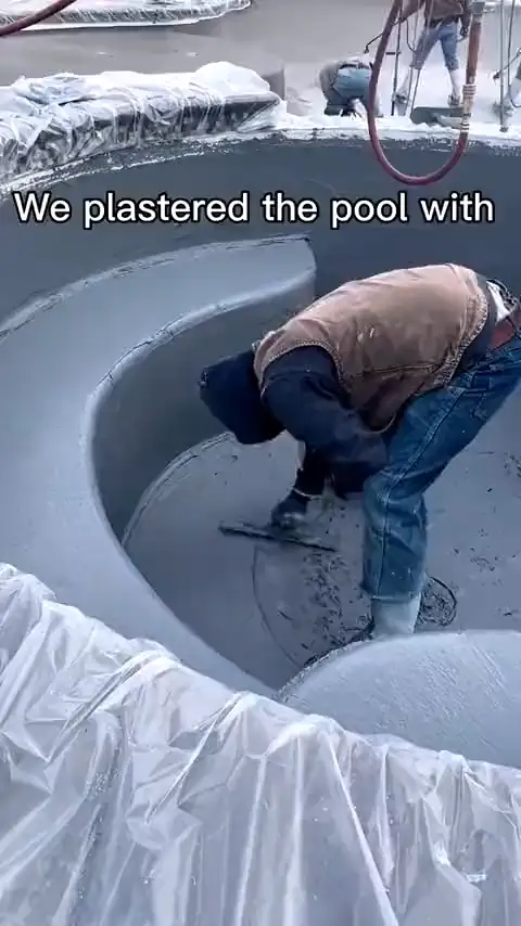 Pebble finish going on a new pool with a beach entry