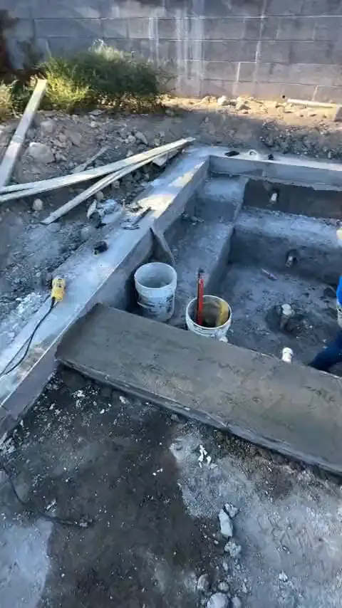 Setting mosaic tile along the waterline by hand