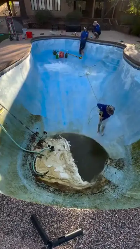 Draining a pool and scrubbing the plaster back to clean