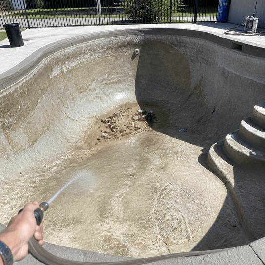 Before: stained plaster in the drained pool