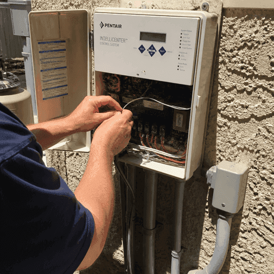 A pool automation panel open at the wiring