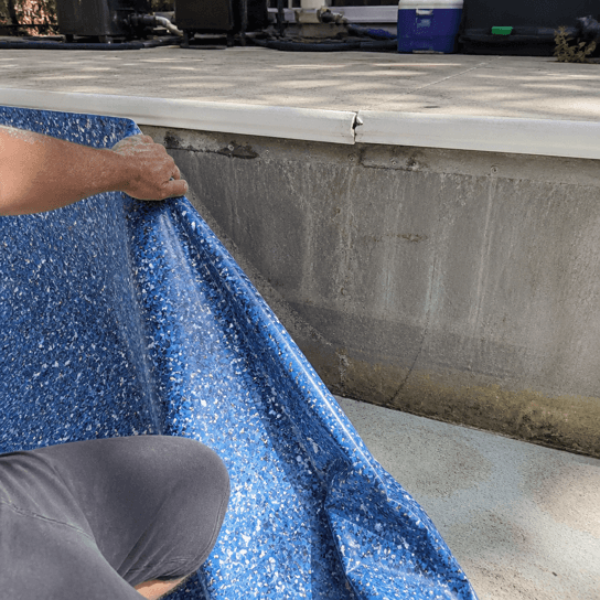 An old vinyl liner pulled back from the wall